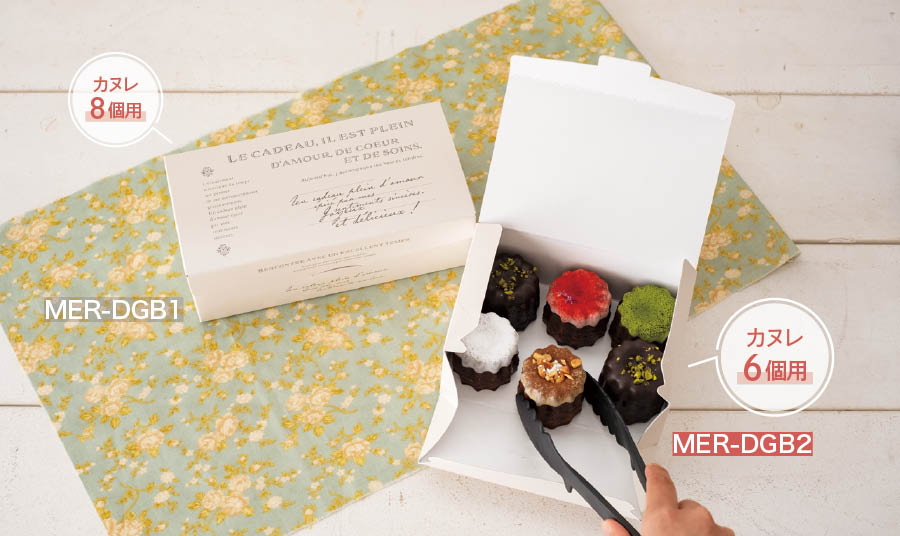 トングで入れやすい横が開くタイプのボックス。直径50×高さ50mm位のカヌレが6個入る大きさです。